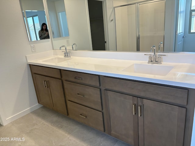 18001 W Lupine Ave, Goodyear, AZ 85338 - bathroom with double vanity, baseboards, and a stall shower