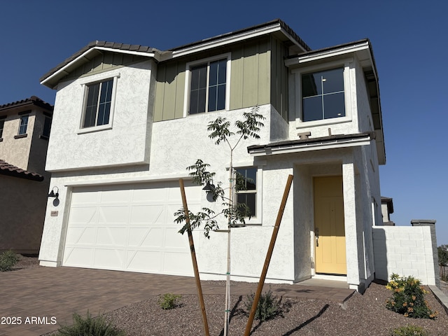 18001 W Lupine Ave, Goodyear, AZ 85338 - view of front of house featuring an attached garage, stucco siding, board and batten siding, and decorative driveway