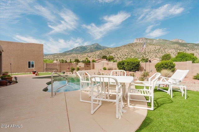 view of pool with a mountain view and a patio