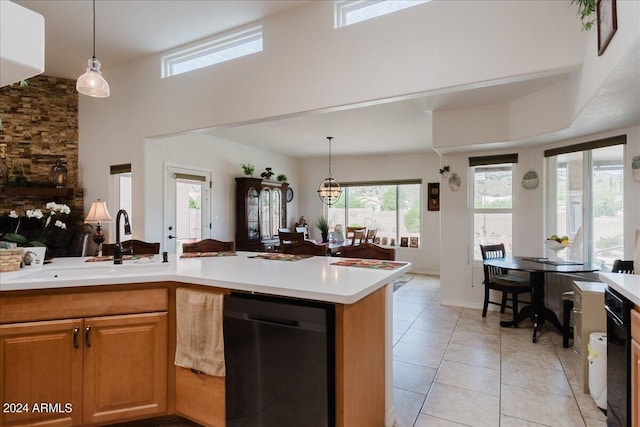 kitchen with sink, decorative light fixtures, a chandelier, black dishwasher, and light tile patterned flooring