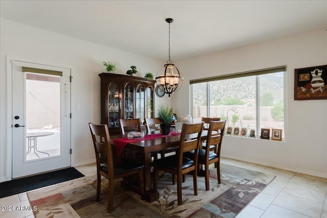 tiled dining area with a chandelier