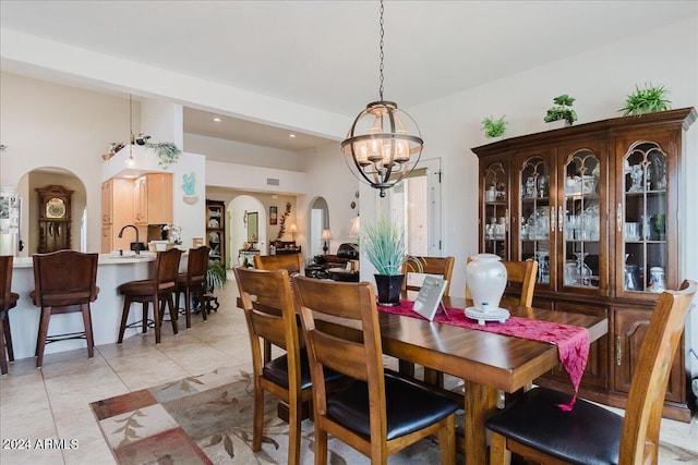 tiled dining room featuring a notable chandelier