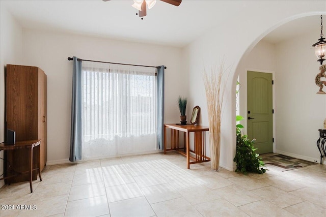 interior space with ceiling fan and light tile patterned floors