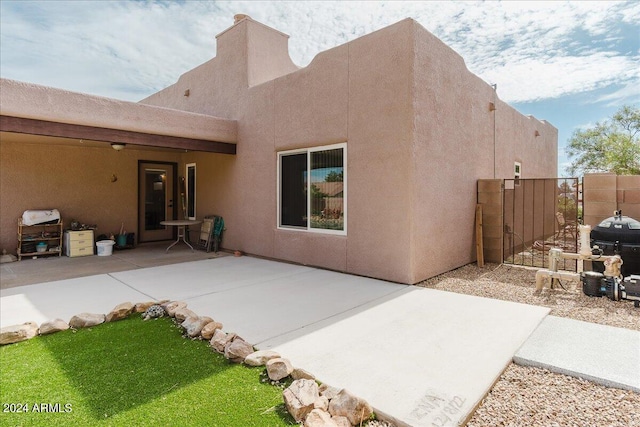 back of property featuring a patio