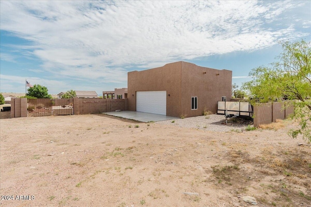 rear view of property with a garage