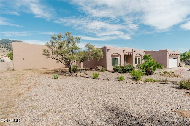 southwest-style home with a garage