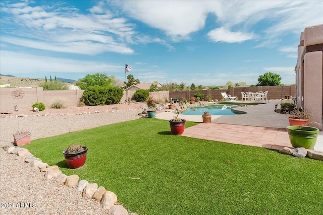 view of yard featuring a fenced in pool and a patio area