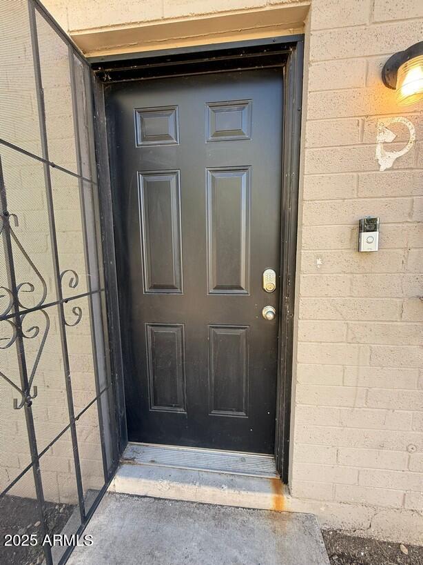 doorway to property featuring concrete block siding