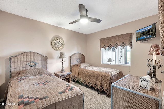 carpeted bedroom with a textured ceiling and a ceiling fan