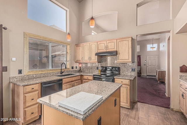 kitchen with a sink, light brown cabinets, black electric range, under cabinet range hood, and stainless steel dishwasher