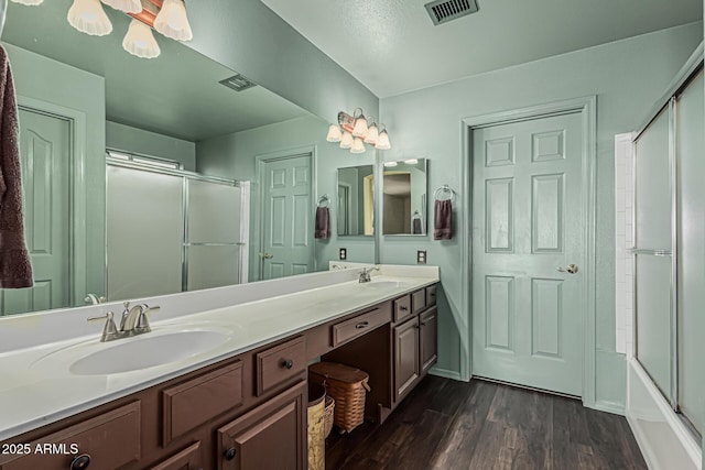 full bathroom with a sink, wood finished floors, and visible vents