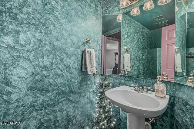 bathroom with visible vents and a sink