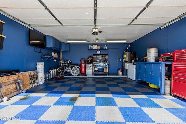 garage with a garage door opener and electric water heater