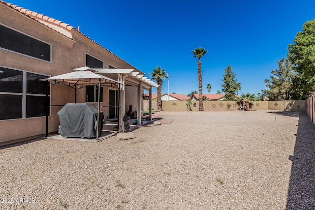 view of yard with a gazebo and a fenced backyard
