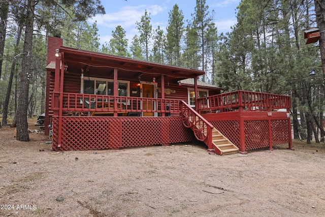 rear view of property with a wooden deck