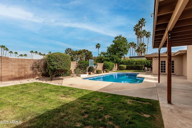 view of swimming pool with a lawn, a fenced in pool, a fenced backyard, and a patio area