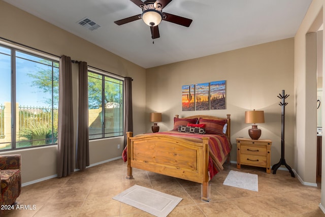 tiled bedroom featuring ceiling fan