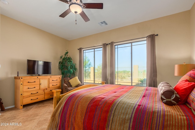 tiled bedroom with access to outside and ceiling fan