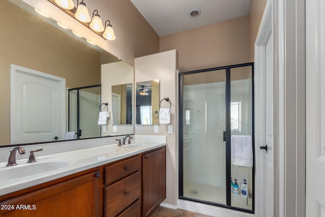 bathroom with vanity, tile patterned floors, and a shower with door