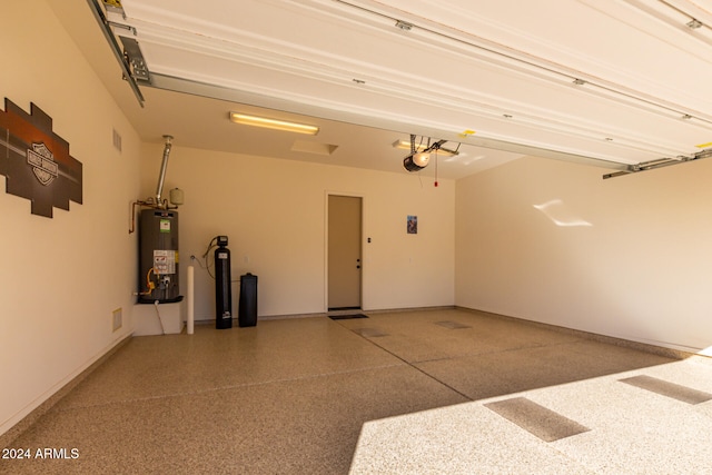 garage with water heater and a garage door opener