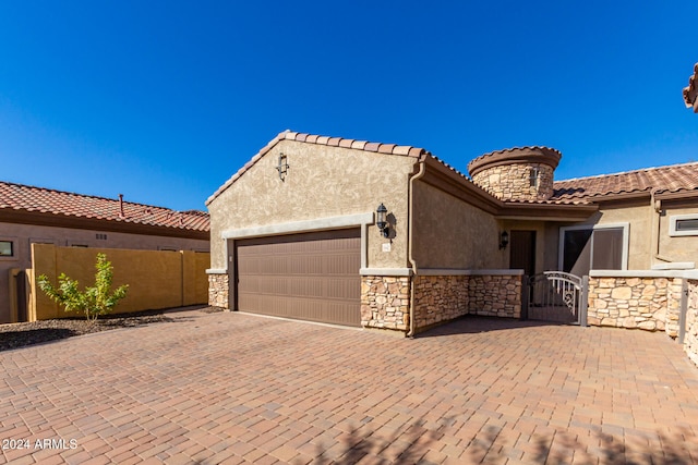 mediterranean / spanish home featuring a garage