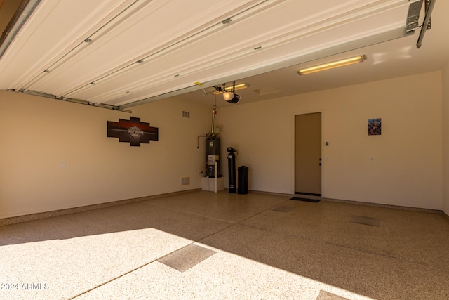 garage with water heater and a garage door opener