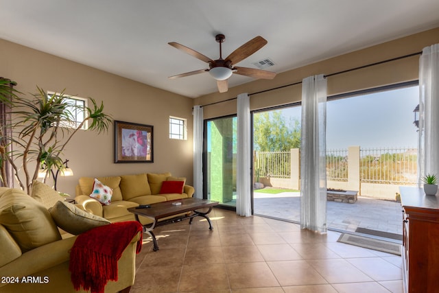 living room with ceiling fan and light tile patterned flooring