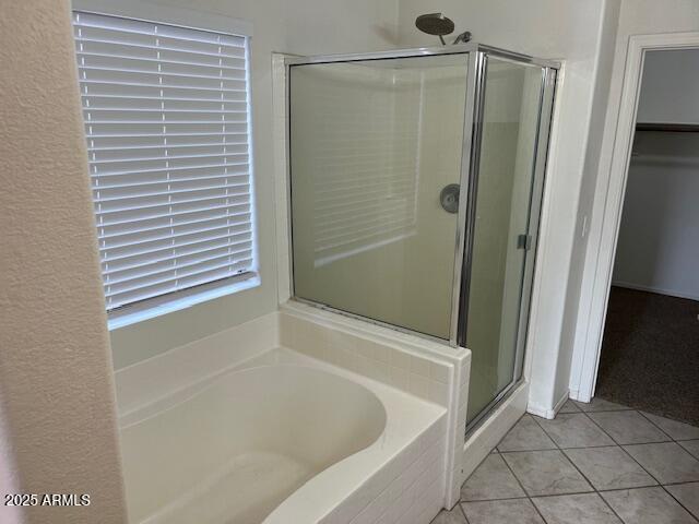 bathroom featuring tile patterned floors and separate shower and tub