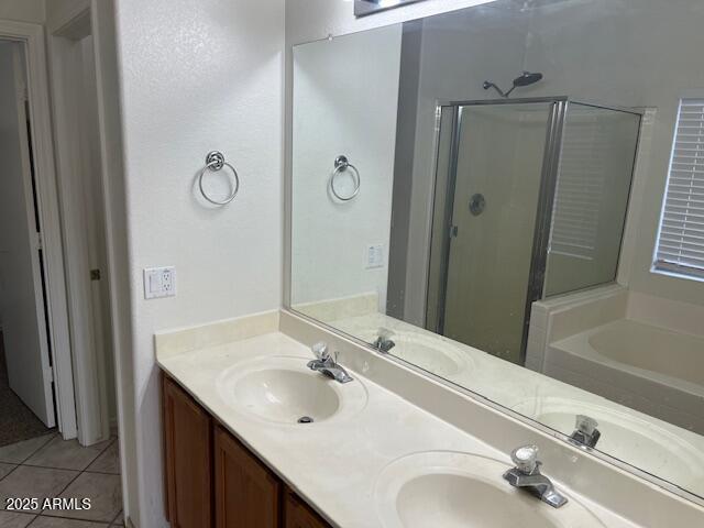 bathroom with tile patterned flooring, vanity, and shower with separate bathtub