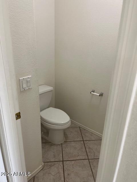 bathroom with tile patterned flooring and toilet