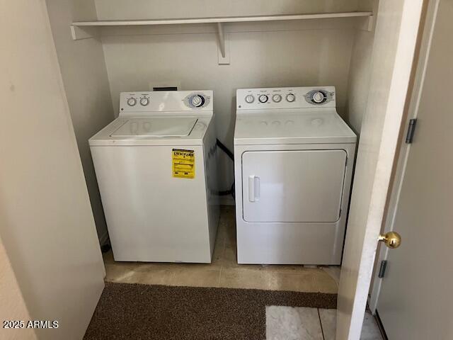 clothes washing area featuring independent washer and dryer