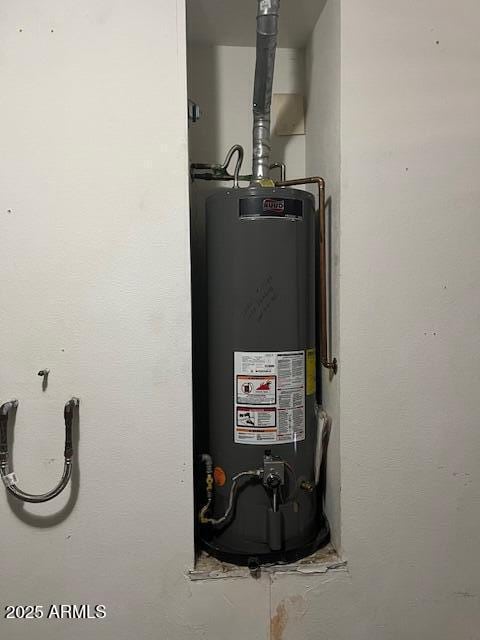 utility room featuring gas water heater