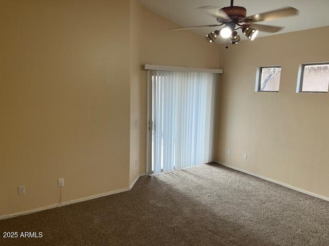 carpeted spare room featuring ceiling fan