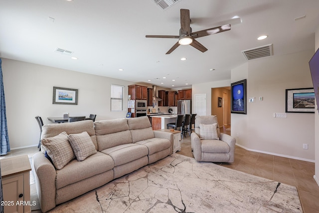 living room with baseboards, light tile patterned flooring, visible vents, and recessed lighting