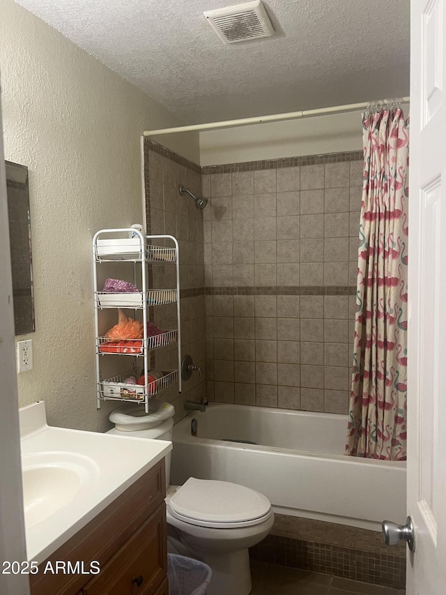 6226 W Citrus Way, Glendale, AZ 85301 - bathroom with a textured wall, a textured ceiling, shower / bath combo with shower curtain, tile patterned floors, and vanity