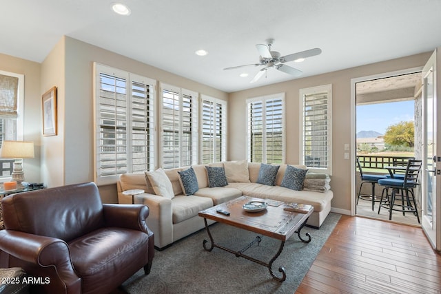 living area featuring recessed lighting, baseboards, hardwood / wood-style floors, and a ceiling fan