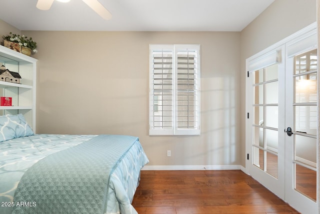 bedroom with french doors, baseboards, and wood finished floors