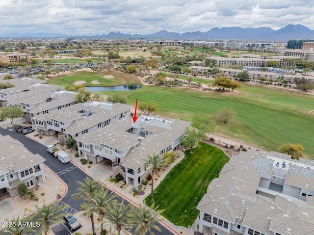 aerial view with golf course view and a water and mountain view