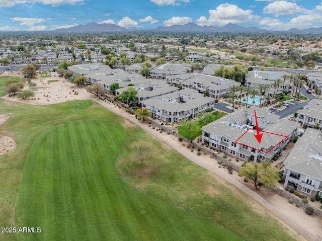 drone / aerial view featuring a mountain view, a residential view, and view of golf course