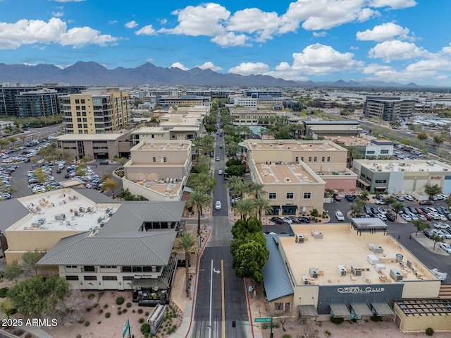 birds eye view of property with a mountain view and a city view