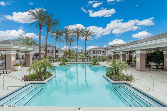 pool featuring a gazebo, a residential view, a patio, and fence