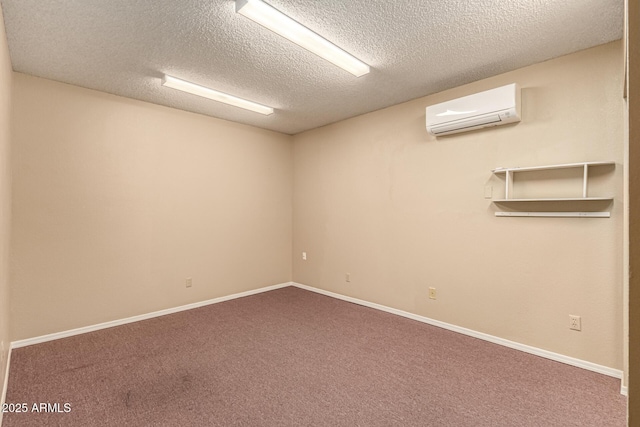 unfurnished room featuring baseboards, carpet, an AC wall unit, and a textured ceiling