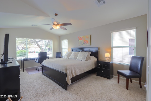 bedroom featuring ceiling fan, light colored carpet, lofted ceiling, and multiple windows