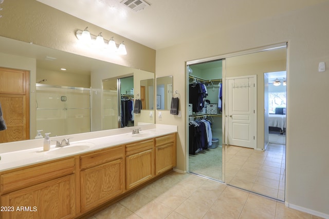 bathroom featuring vanity, an enclosed shower, and tile patterned floors