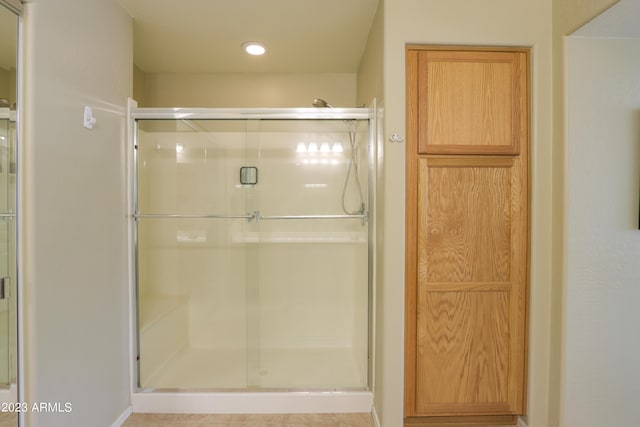 bathroom with a shower with shower door