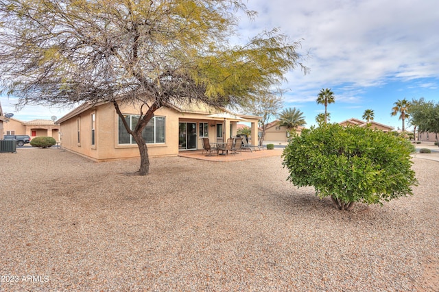 rear view of property featuring cooling unit and a patio