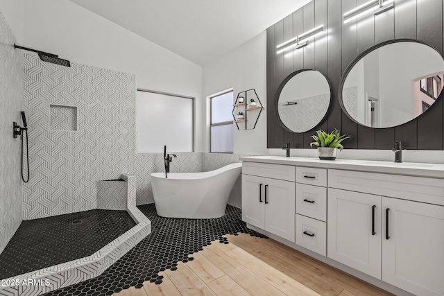 6935 W Monte Lindo St, Glendale, AZ 85310 - full bathroom with a walk in shower, double vanity, vaulted ceiling, a freestanding tub, and tile walls