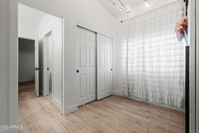 6935 W Monte Lindo St, Glendale, AZ 85310 - unfurnished bedroom featuring light wood-type flooring, rail lighting, and a closet