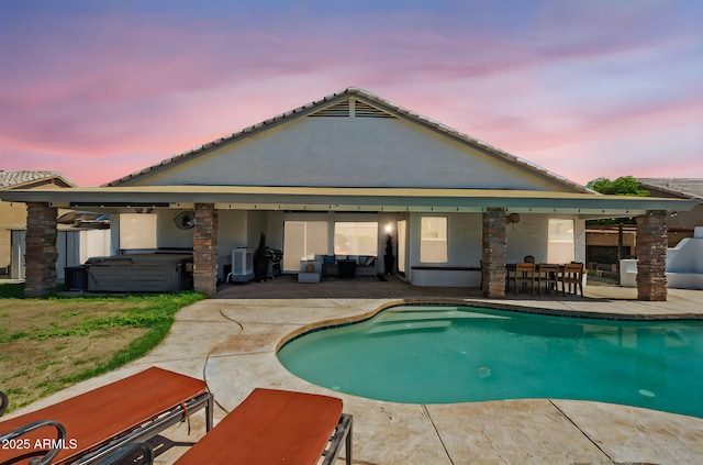 6935 W Monte Lindo St, Glendale, AZ 85310 - back of property featuring a hot tub, a patio area, an outdoor pool, and outdoor dining space