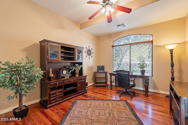 home office with dark wood-type flooring and ceiling fan